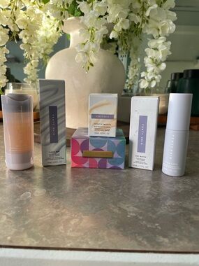 Fenty Beauty skincare set with white, cream, pink, purple, gold accents